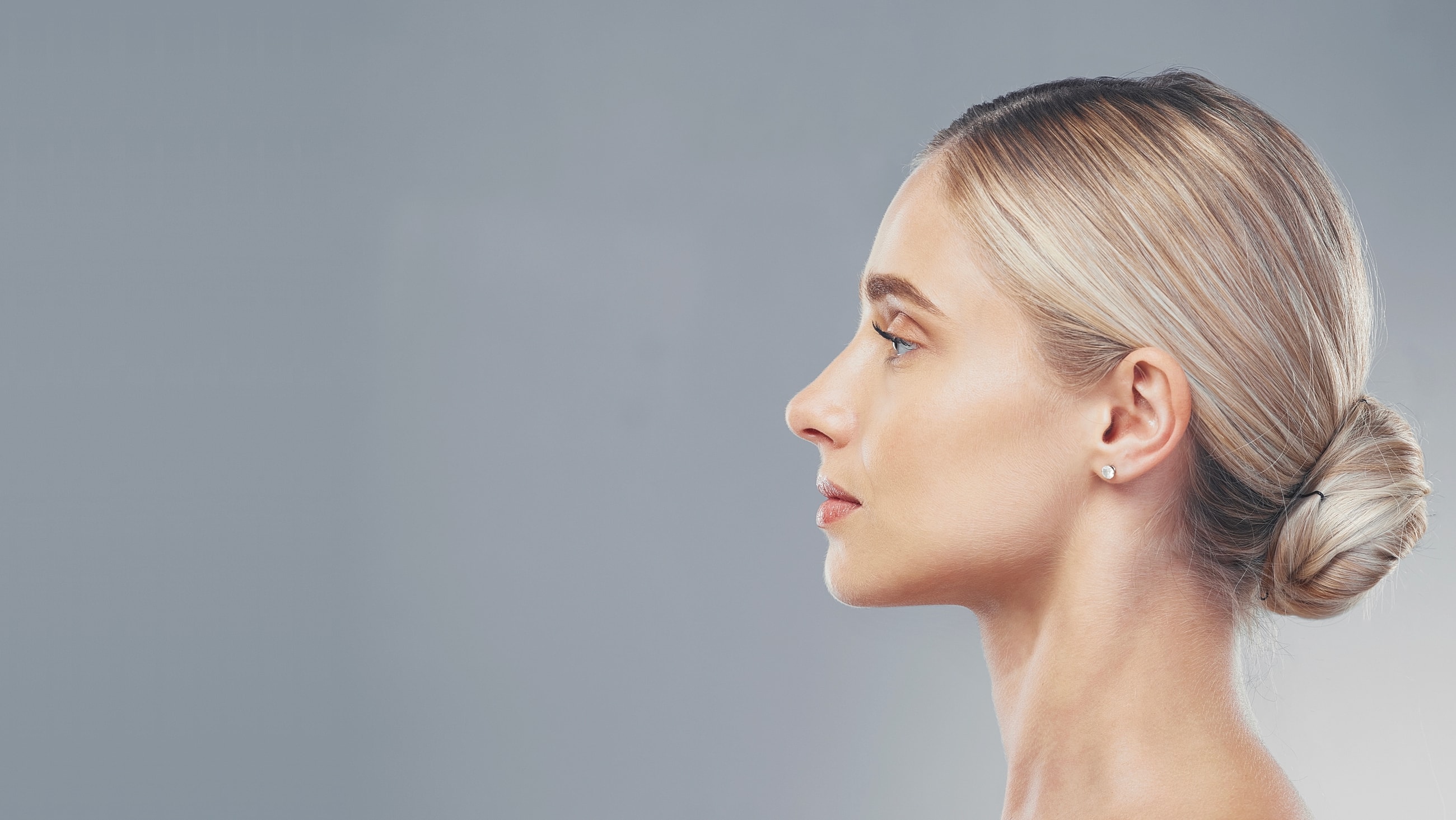 Profile view of a woman with elegant hairstyle.