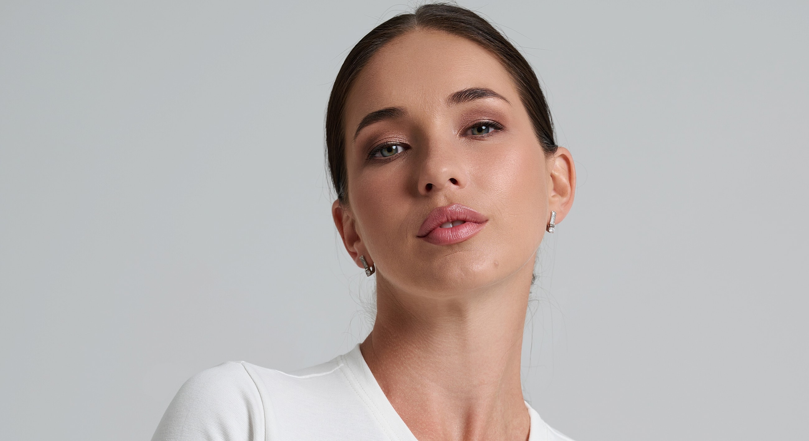 Woman with a confident expression against a plain background.